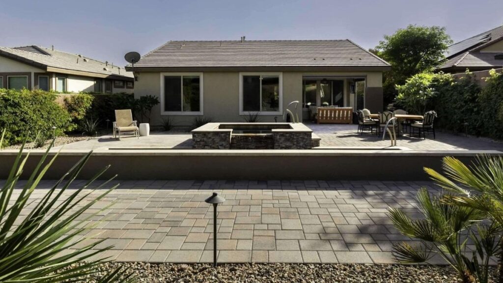 beautiful backyard jacuzzi home with cobblestone floors