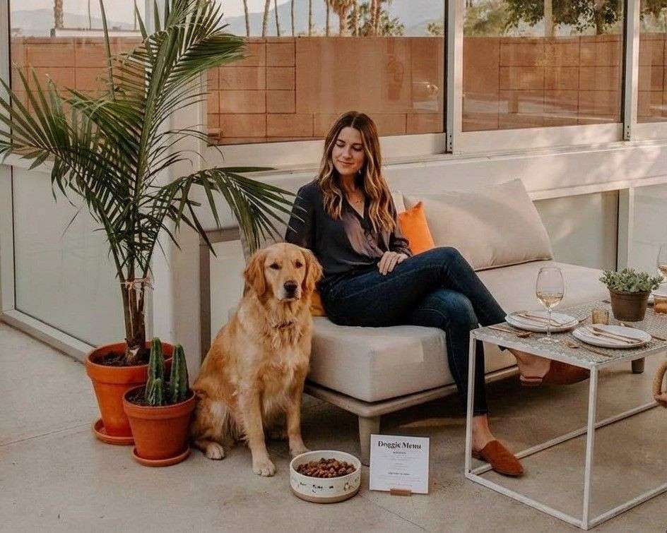 A women and her dog waiting to have dinner at Boozehounds