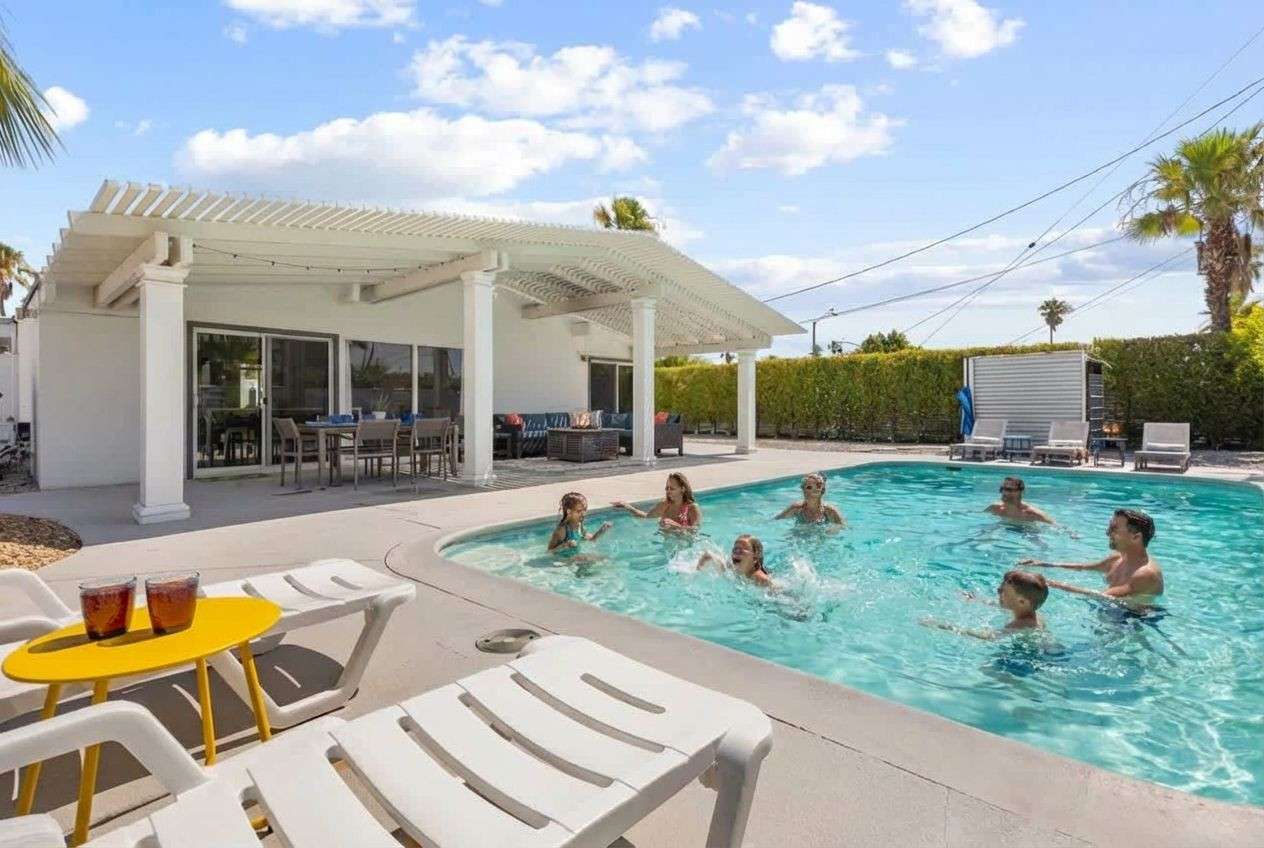 Family enjoying the swimming pool at a Apek property