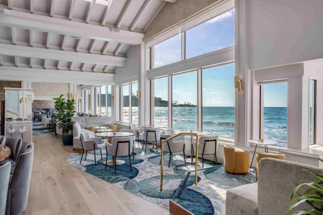 Waves crashing against The Marine Room windows