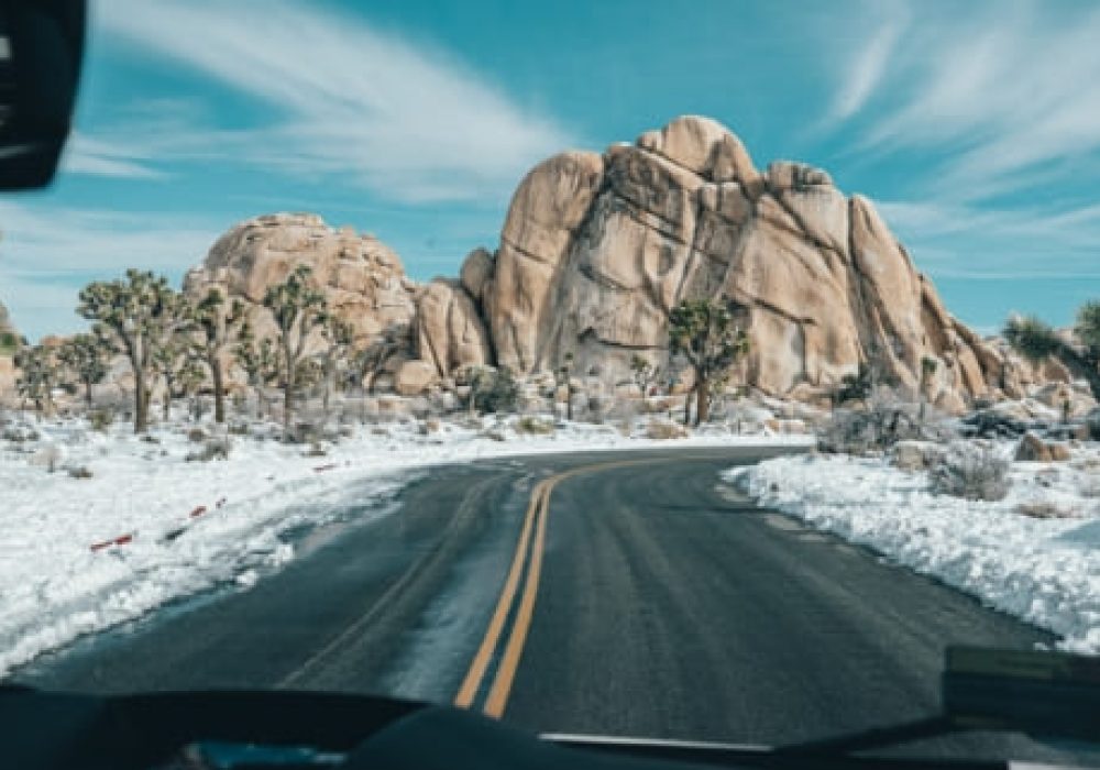 snowy road with mountain ahead